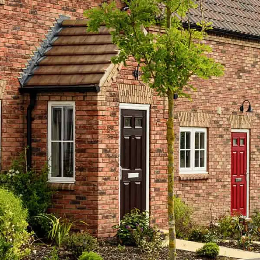 a brick house with a tree and a door