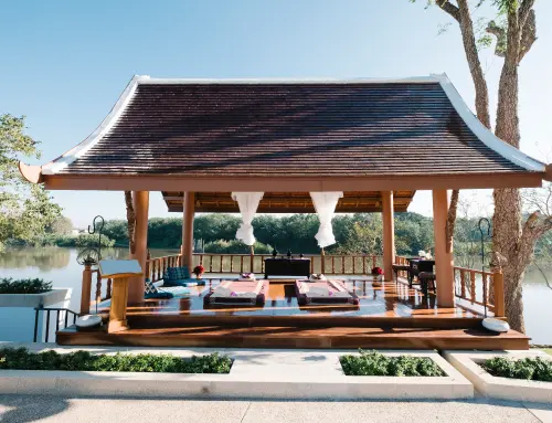 a wooden gazebo with a roof and a railing