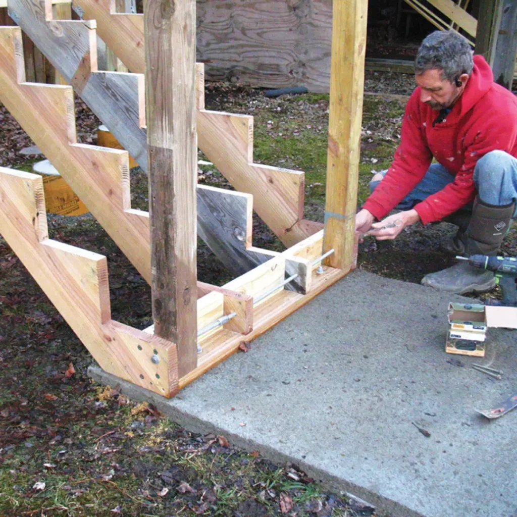 a person working on a wood stair case