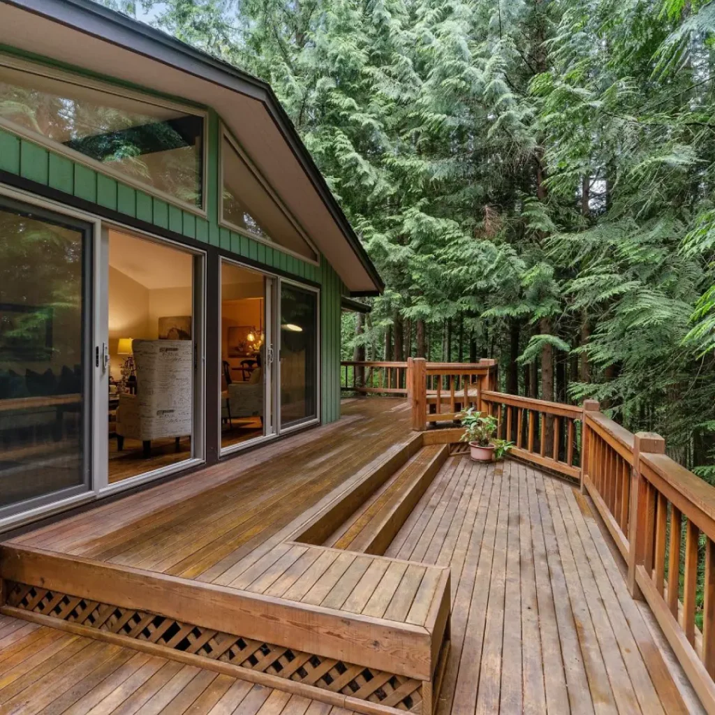 a deck with a wood deck and a large window