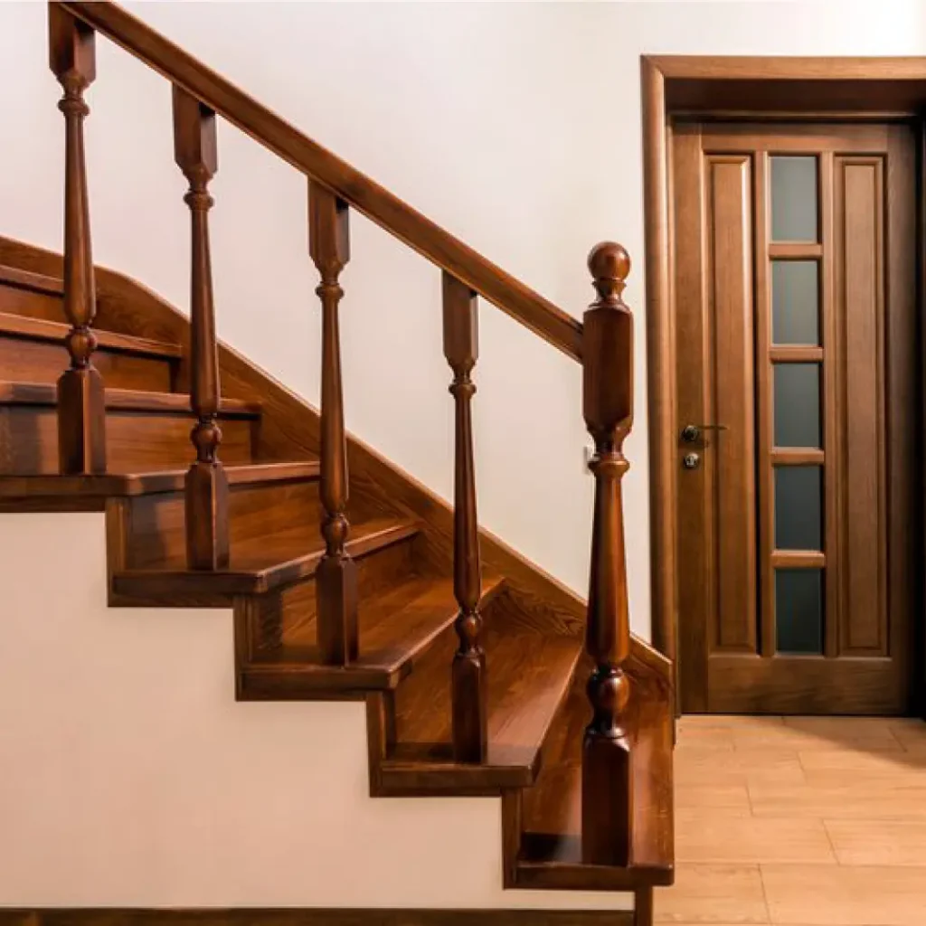 a wooden staircase with a door and glass door